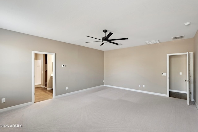 unfurnished bedroom with ceiling fan, light colored carpet, and ensuite bath