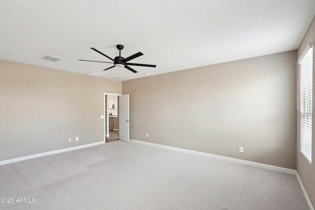 carpeted empty room featuring ceiling fan