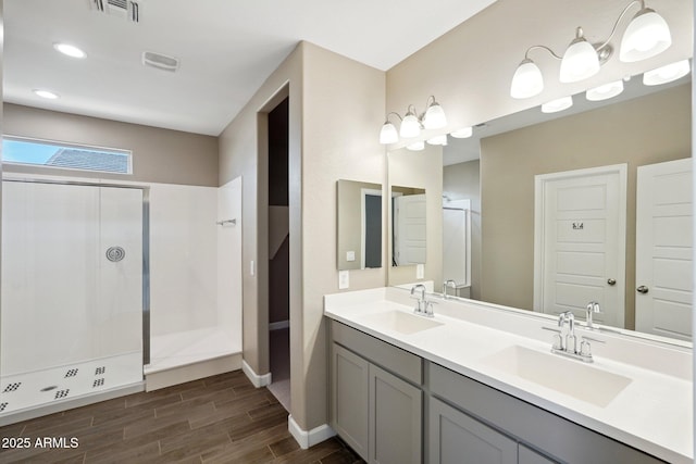 bathroom featuring vanity and a shower with shower door