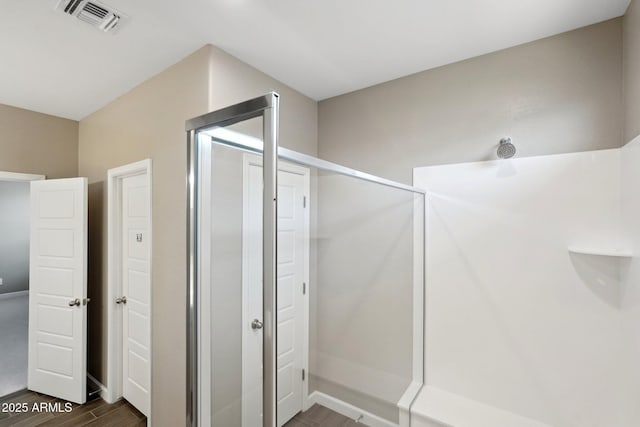 bathroom with hardwood / wood-style floors and walk in shower