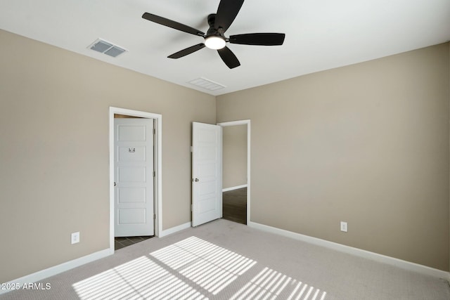 unfurnished bedroom featuring ceiling fan and light colored carpet