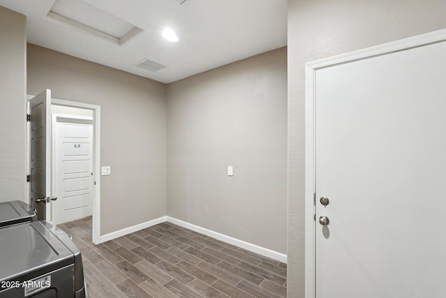 washroom with dark wood-type flooring and washing machine and clothes dryer