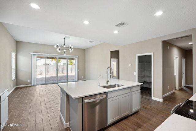 kitchen with dishwasher, sink, a chandelier, hanging light fixtures, and a kitchen island with sink