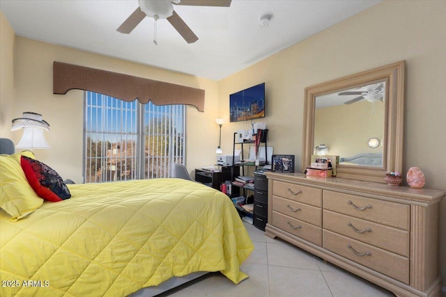 tiled bedroom featuring ceiling fan