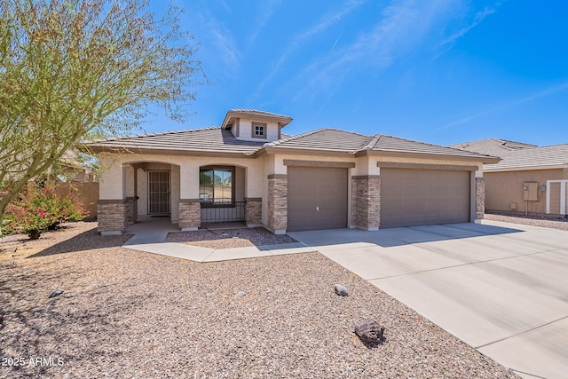 1520 N Milly Pl, Casa Grande, AZ 85122 - view of front of house with stone siding, stucco siding, a tile roof, and an attached garage