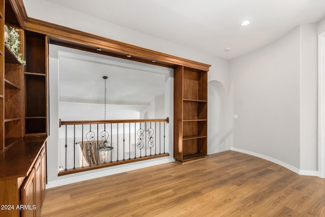 unfurnished room with wood finished floors, baseboards, and recessed lighting