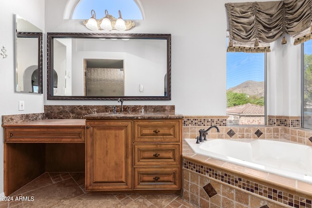 full bathroom with a garden tub and vanity