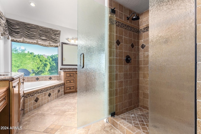 full bath featuring a shower stall, vanity, and a bath