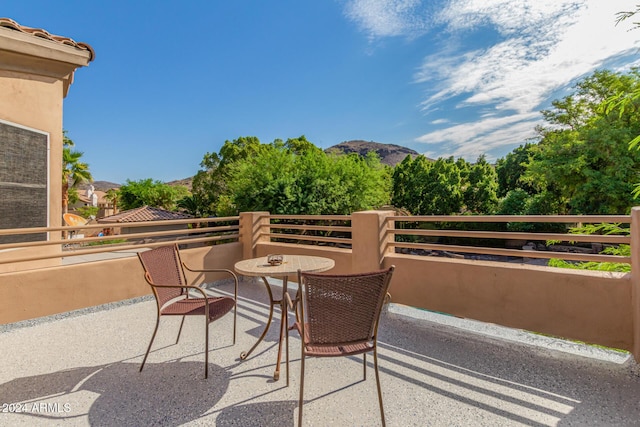 view of patio featuring a mountain view and a balcony