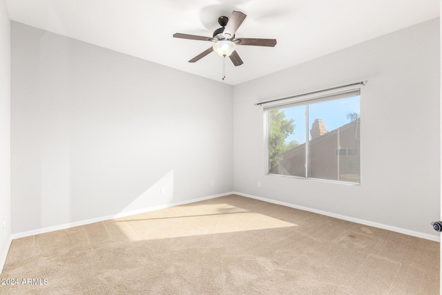 unfurnished room featuring carpet flooring and baseboards