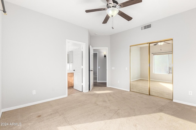 unfurnished bedroom featuring carpet, a closet, connected bathroom, and baseboards