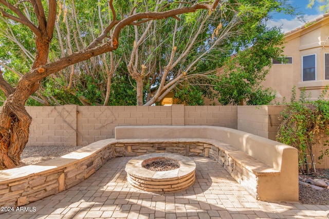 view of patio / terrace featuring a fire pit and fence