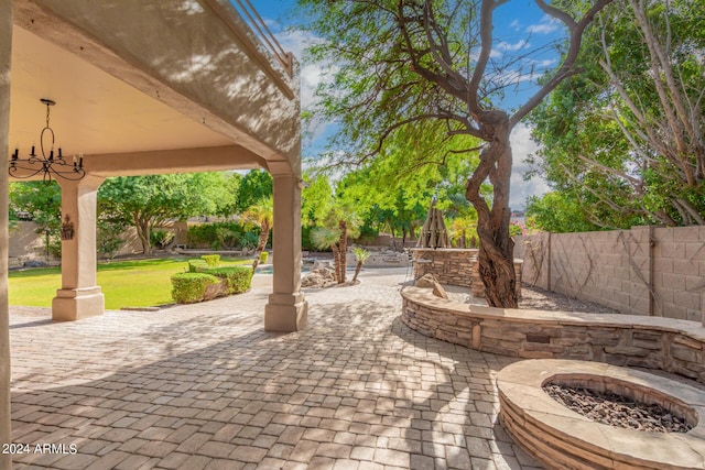 view of patio / terrace featuring a fenced backyard, an outdoor fire pit, and a gazebo
