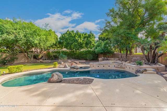 view of pool with a fenced backyard, a patio area, and a hot tub