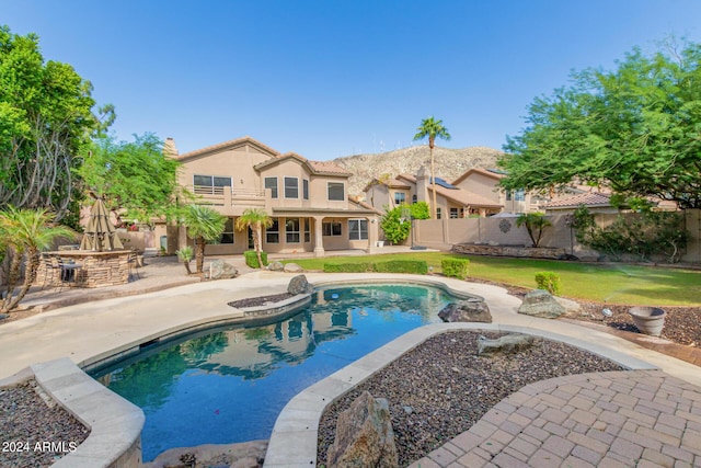 view of swimming pool featuring a patio and a mountain view