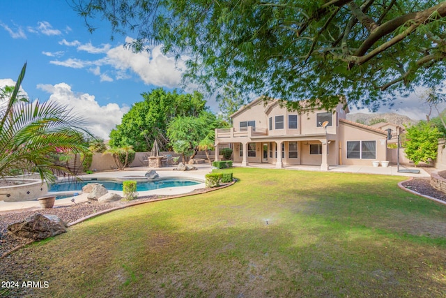 rear view of property with a hot tub, a patio area, and stucco siding