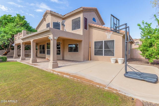 back of house featuring a tiled roof, stucco siding, and a patio area