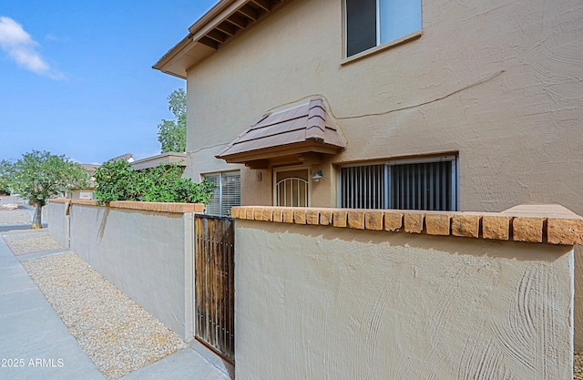 view of front of property featuring fence and stucco siding