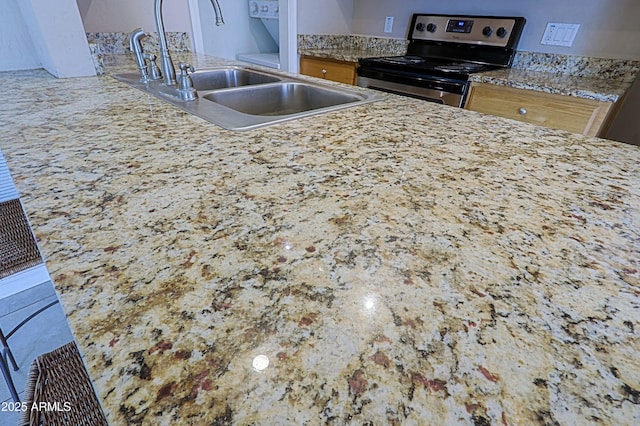 kitchen with stainless steel electric range and a sink