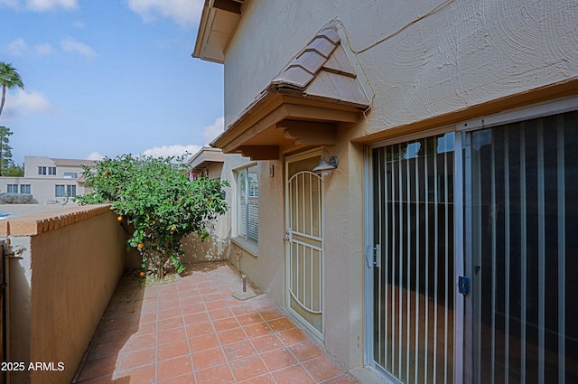 exterior space featuring fence and stucco siding