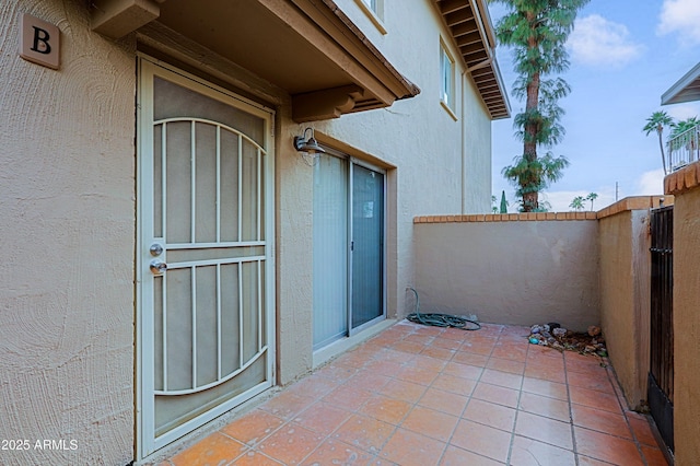 exterior space with a patio area, fence, and stucco siding