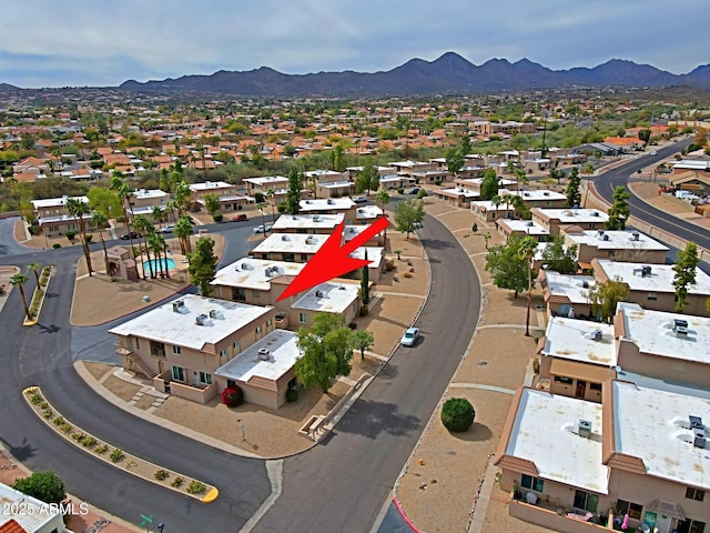 drone / aerial view featuring a residential view and a mountain view