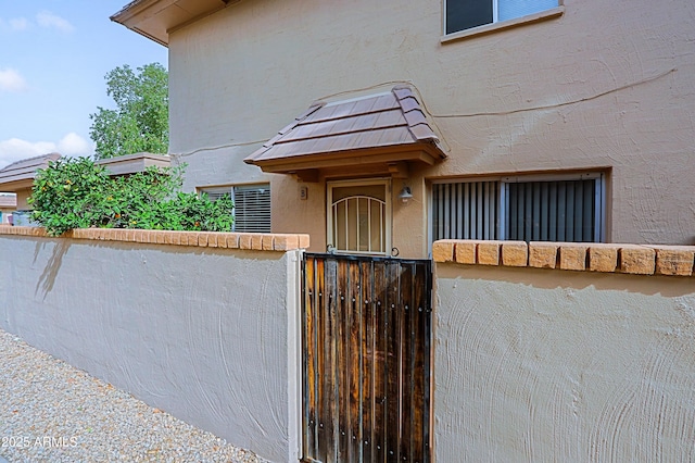 doorway to property featuring stucco siding