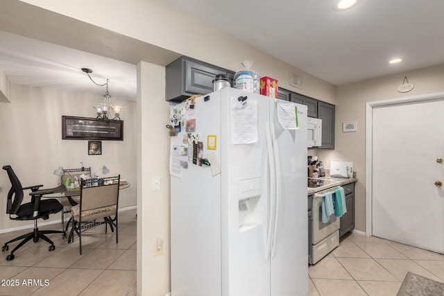 kitchen featuring recessed lighting, white appliances, gray cabinetry, and light tile patterned floors