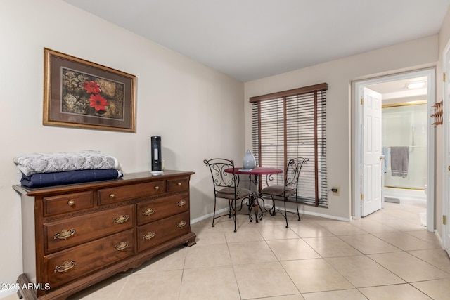 dining space with light tile patterned floors and baseboards