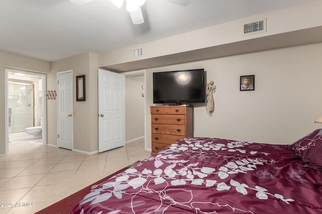 tiled bedroom featuring a ceiling fan, visible vents, baseboards, and ensuite bathroom