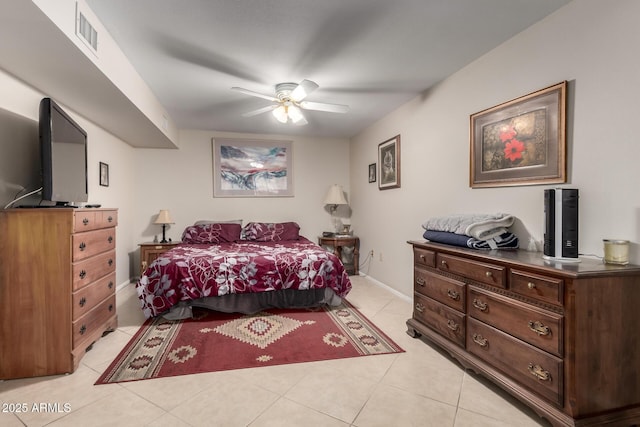 bedroom featuring a ceiling fan, visible vents, baseboards, and light tile patterned floors