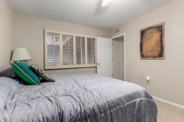 bedroom featuring ceiling fan, tile patterned flooring, visible vents, and baseboards