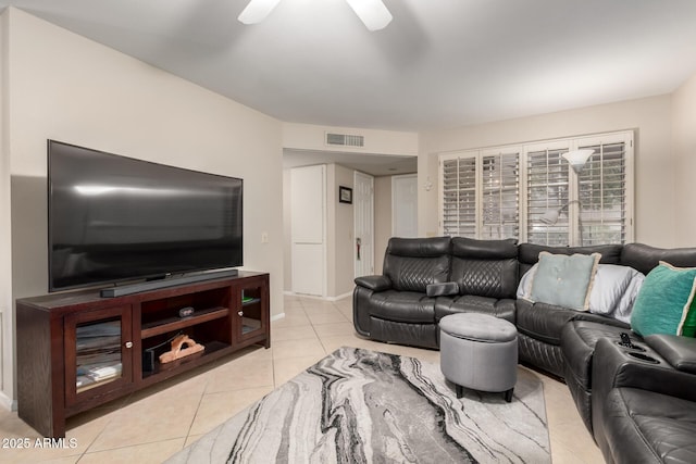 living room with a ceiling fan, visible vents, baseboards, and light tile patterned floors