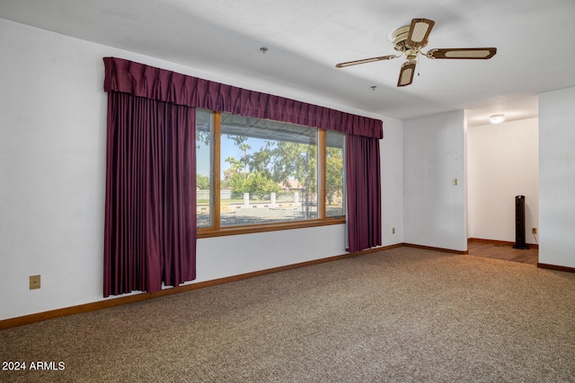 spare room featuring ceiling fan and carpet