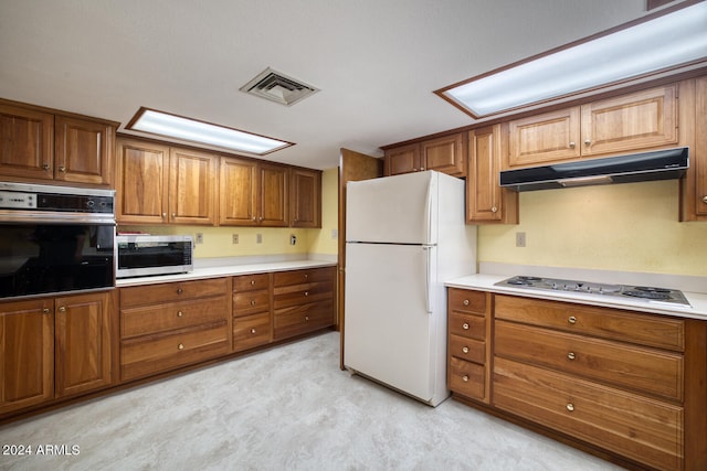 kitchen with white appliances and light colored carpet