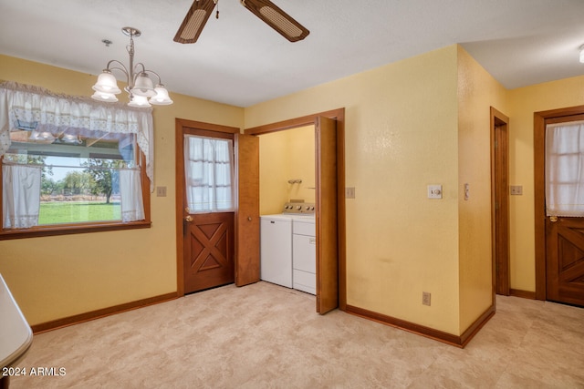 washroom with washing machine and clothes dryer, plenty of natural light, light colored carpet, and ceiling fan with notable chandelier