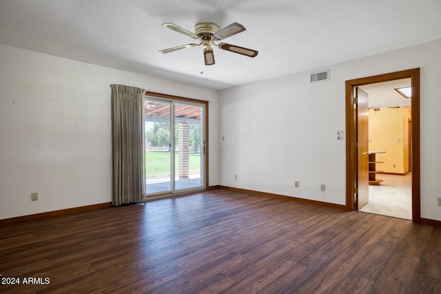 spare room with ceiling fan and dark wood-type flooring