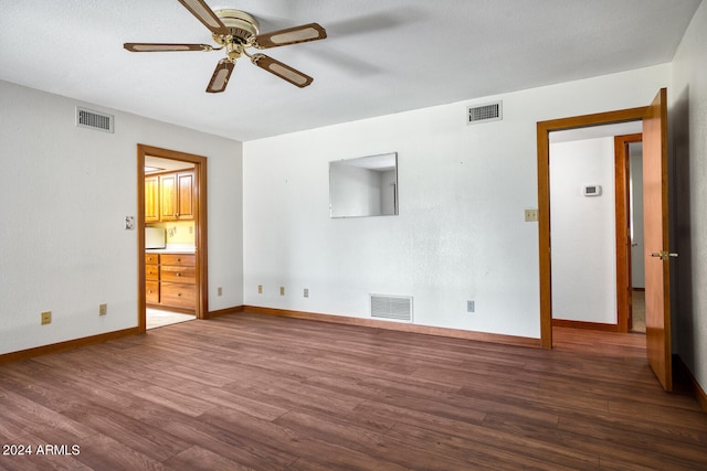 interior space featuring hardwood / wood-style floors, ceiling fan, and a textured ceiling