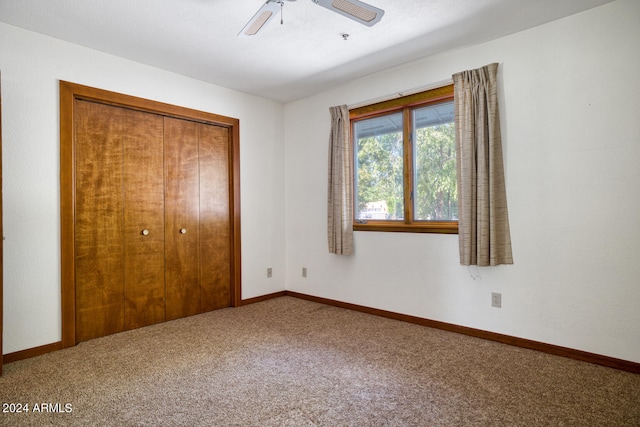 unfurnished bedroom featuring carpet, a closet, and ceiling fan