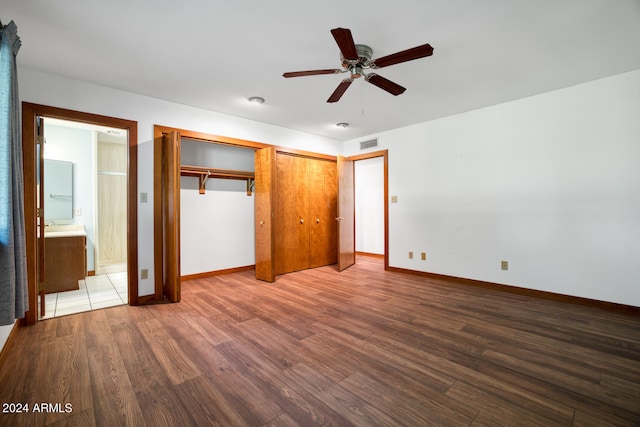 unfurnished bedroom featuring connected bathroom, ceiling fan, and hardwood / wood-style flooring