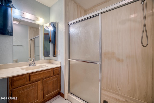 bathroom featuring tile patterned floors, vanity, and walk in shower