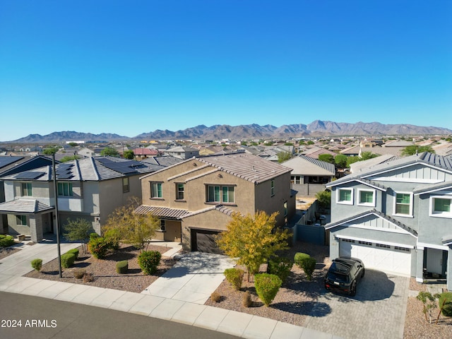 view of front of property with a mountain view and a garage