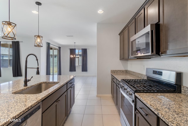 kitchen with pendant lighting, appliances with stainless steel finishes, sink, and plenty of natural light