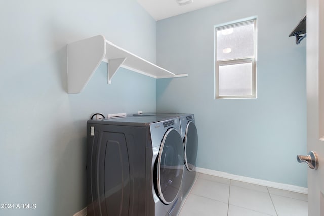 laundry room featuring separate washer and dryer and light tile patterned floors