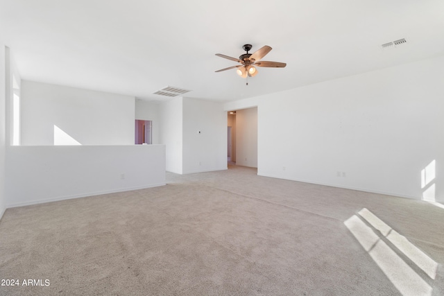 spare room featuring ceiling fan and light colored carpet