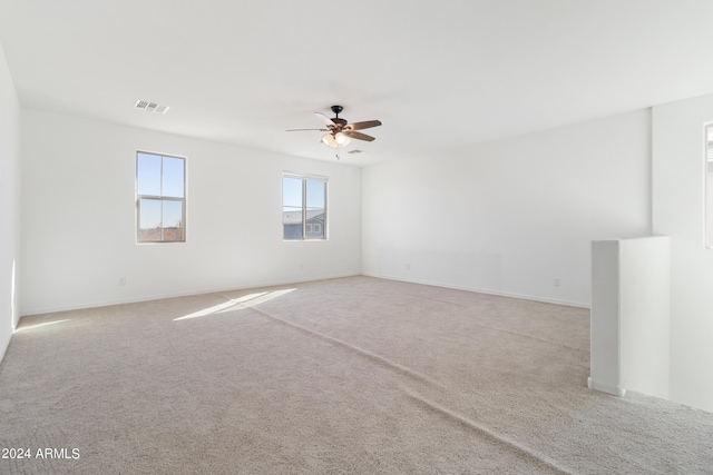 empty room with light carpet and ceiling fan