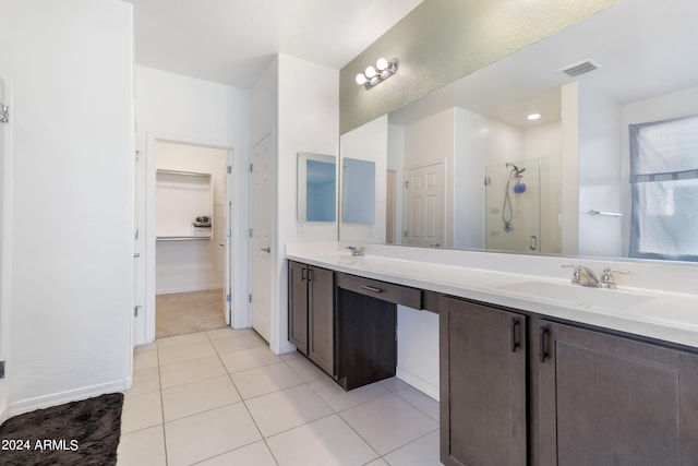 bathroom featuring vanity, tile patterned floors, and walk in shower