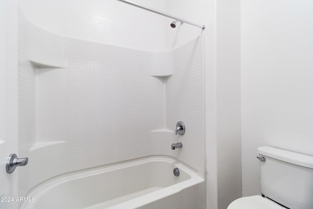 bathroom featuring toilet and shower / bathtub combination