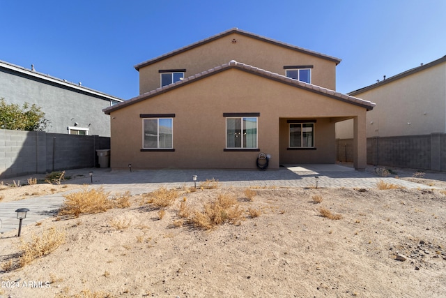 rear view of property featuring a patio