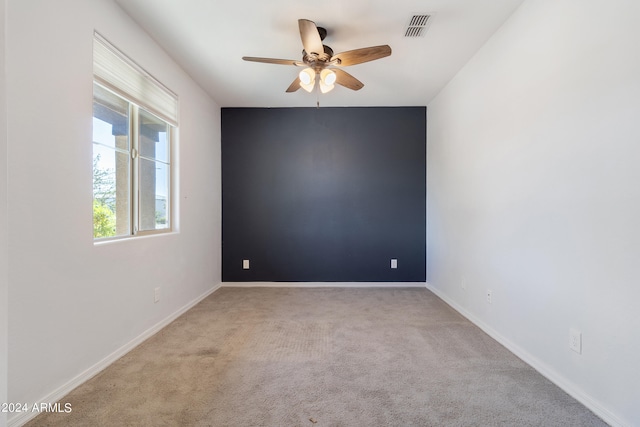 carpeted spare room with ceiling fan